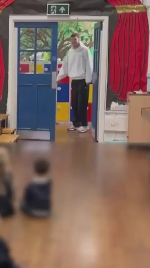 [BBC Sport] Sam Heathcote, Macclesfield FC player, is greeted at the school where he is PE teacher after the FA Cup giant-killing v Crystal Palace