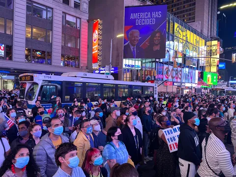 Crowd in Times Square standing in silence listening to President-elect Biden address the nation.