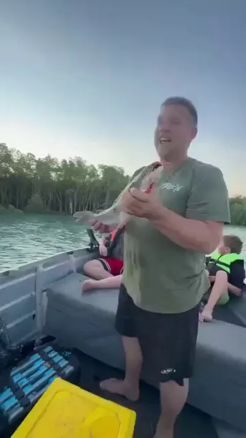 While out fishing with his family, This man noticed an eagle circling above their boat. Realizing it was eyeing the fish he had just caught, he tossed it into the air and the eagle swooped down gracefully to snatch it mid flight.