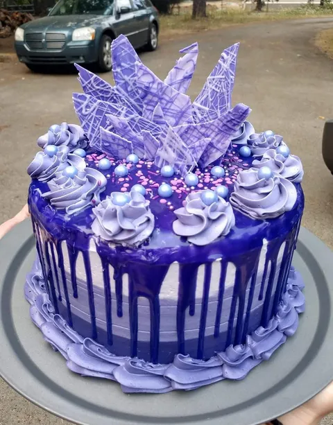 [Homemade] Dark chocolate cake filled with dark chocolate mousse, topped with buttercream, white chocolate ganache, and white chocolate candies.
