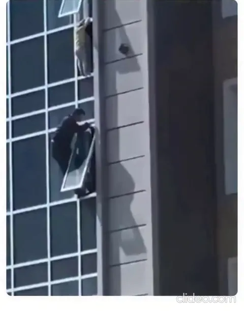A man climbed out of an eighth-floor window to save a three year old child.