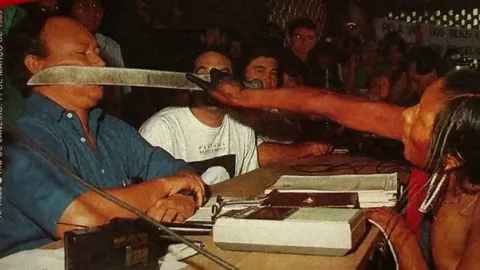 Indigenous rights activist and environmentalist Tuira Kayapó brandished her machete in the face of a Brazilian government official, who was trying to convince indigenous leaders to accept a mega-dam project in the Amazon, 1989.