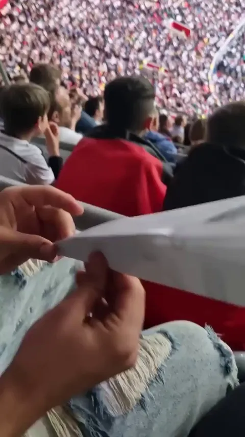 A football fan scores goal with paper plane