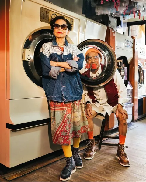 Taiwanese couple wear clothes that were left behind at their laundromat.
