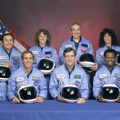 The Challenger crew smiling for photos before boarding their shuttle in 1986. Just 73 seconds after launch, the spacecraft exploded, killing all seven astronauts. The photo captures the calm moments before one of the most infamous space disasters in history.