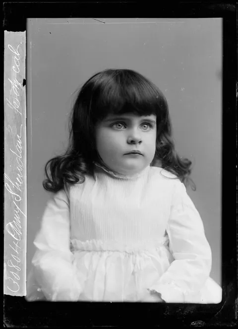 Sharp Glass negative of a little girl, posing for the damera, 1890s.