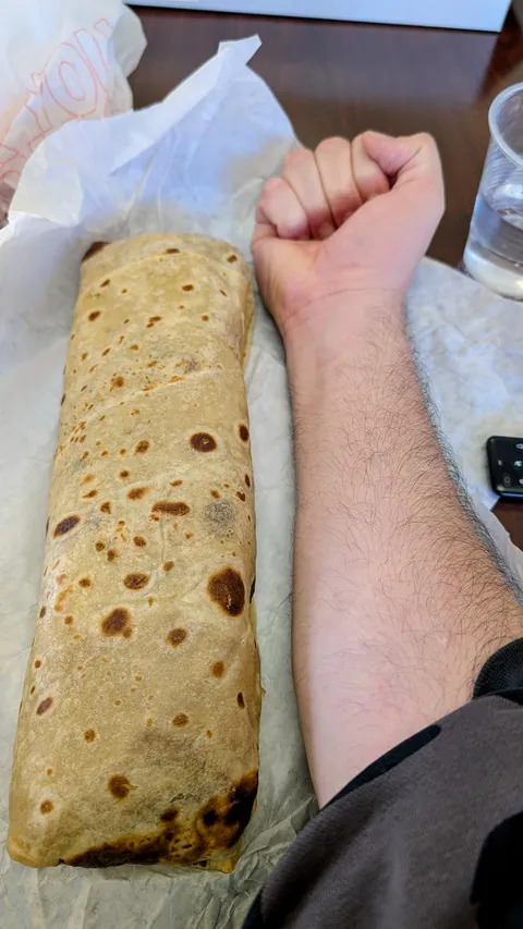 I'm 6'4" and this breakfast burrito is bigger than my fore arm.