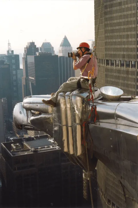 Checking the steel spire of the Chrysler Building for water leaks, New York