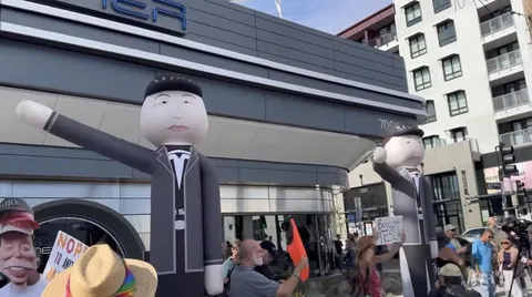 Protesters at the Tesla diner and there's Inflatable Elon Musk outside the Tesla diner in Hollywood
