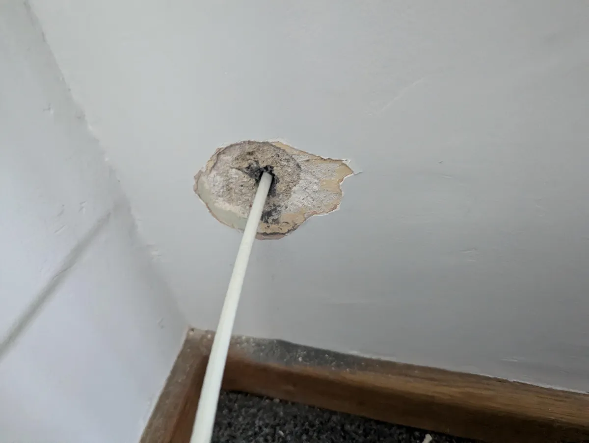 Virgin media blew my wall drilling a hole, what's the best way to fix this?