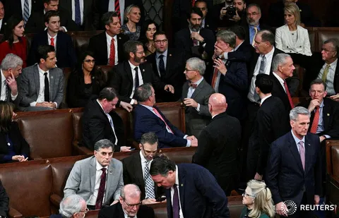Rep. Mike Rogers is grabbed by the face in order to be restrained from lunging at Rep. Matt Gaetz