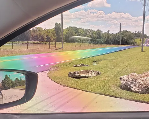 The sun hit this freshly-paved tarmac just right and made a real-life Rainbow Road through polarized lenses.