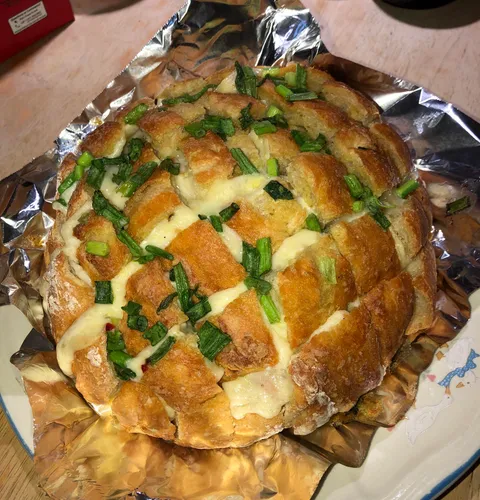 [I ate] Homemade cheesy garlic pull apart bread topped with melted butter and scallions