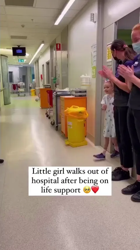 Hospital decide to give a Little girl a standing ovation as she walks out of hospital HEALTHY after being on life support