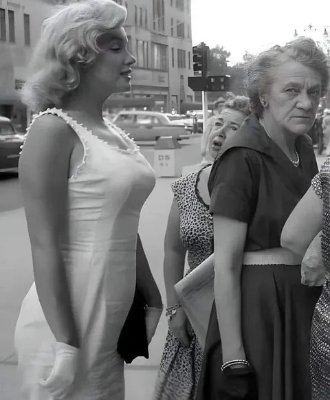 Marilyn Monroe in line for a hot dog, New York, 1957