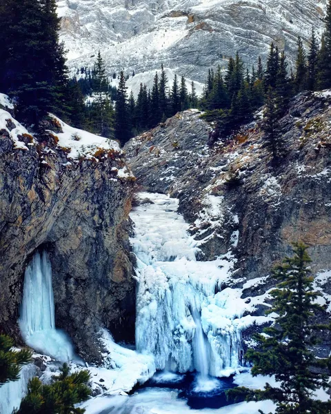 Hiked to an almost completely frozen waterfall, Kananaskis, Alberta [2246x2807] [OC]