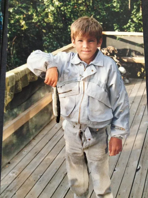 In honor of his 42nd birthday, here's Ryan Reynolds back in 1983 holding a dead fish... with his fly open