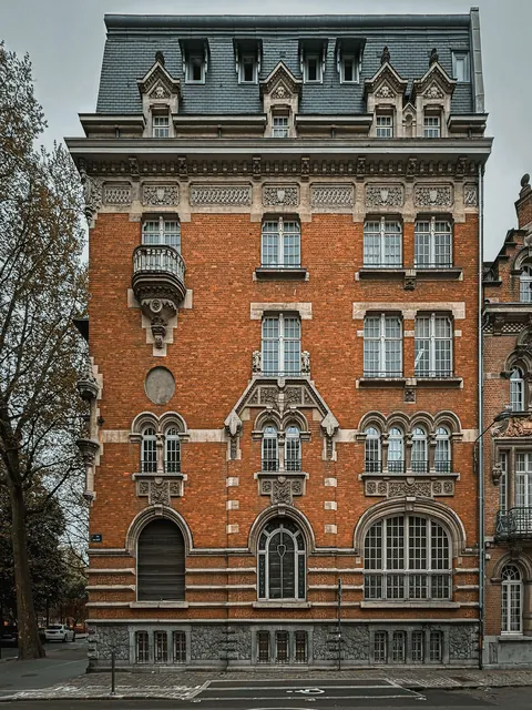 Side of an eclectic-style building with a mansard roof in Lille, northern France.