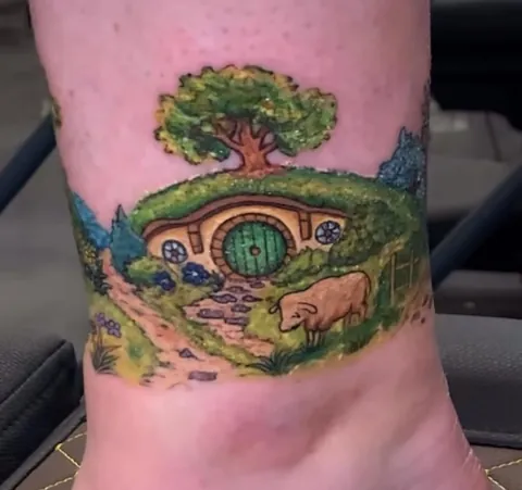 Thought I’d put a towel on my ottoman so that I could rest my new tattoo without getting cat hair on it