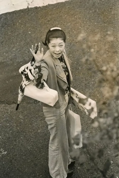In 1974, Masahisa Fukase photographed his wife, Yōko Wanibe, every morning from the window of their apartment in Tokyo as she left for work.