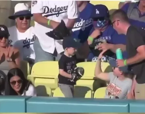 The kid's face is pure joy after getting a ball, and then he pulls a plot twist by giving it to the girl next to him, what a little gentleman!