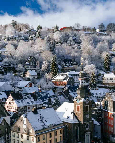 1789 Evangelische Stadtkirche(Evangelical City Church) with an onion cupola and the hillside houses in the resort town of Monschau, Eifel region, Aachen, western Germany.