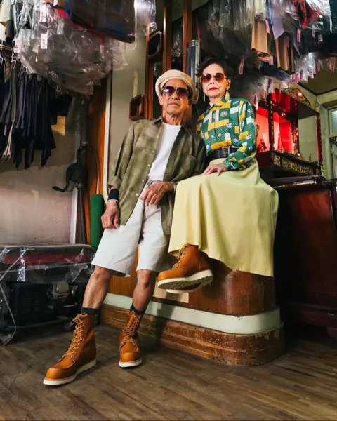 Taiwanese couple wear clothes that were left behind at their laundromat.