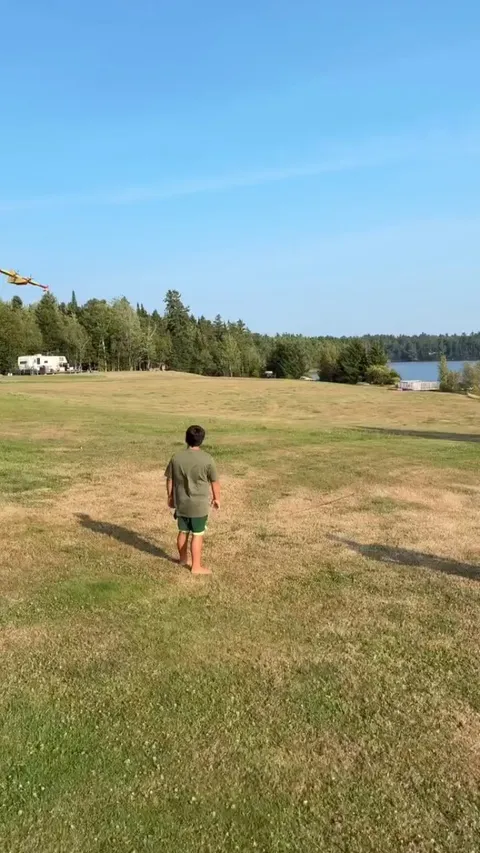 A waterbomber refills in a lake to continuing fighting the wildfires in Canada