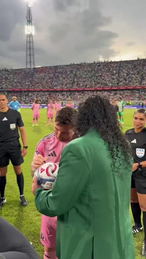 Legendary Colombian goalkeeper René Higuita attempts his famous scorpion kick against Lionel Messi.