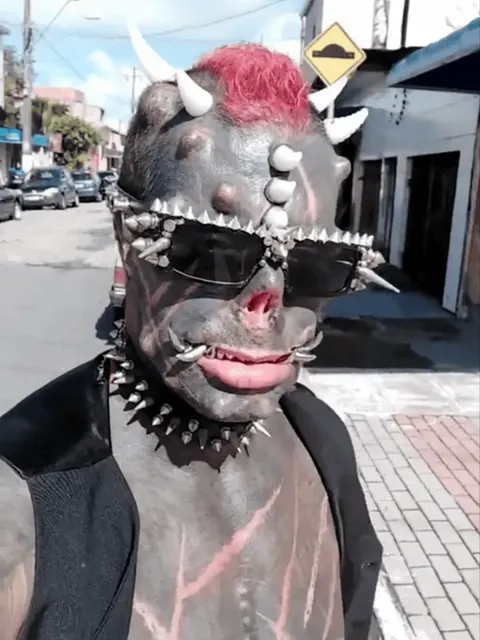[Sensitive Content] Michel Praddo, known as "Diabão" (big devil), celebrated the end of the mask mandate by completely removing his ears. Around 85% of his body is covered in ink, he turns 50 later this year.