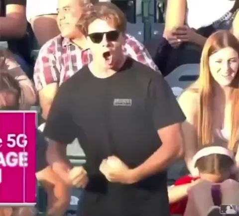 Guy gives the ball to kid and kid returns the favor