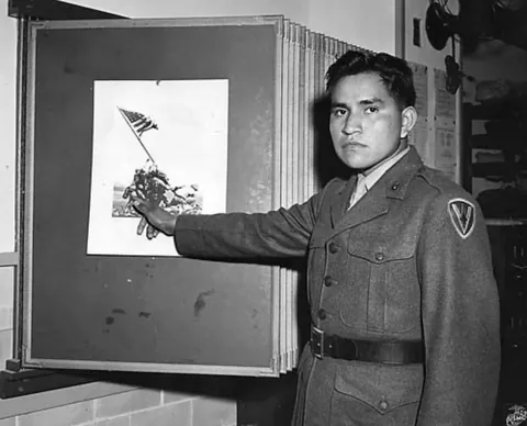 Ira Hayes, a Native American marine immortalized raising the American flag over Iwo Jima, sits in a Los Angeles jail cell (1953). Crippling PTSD and unwanted fame saw Hayes arrested 52 times for public intoxication after the war. He froze to death in the Arizona desert while drunk in 1955.