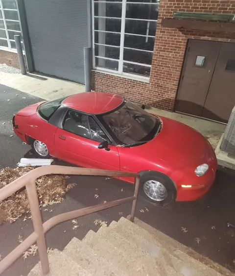 A GM EV1 casually decaying outside of a building at my university. All but a dozen or two of these were crushed.