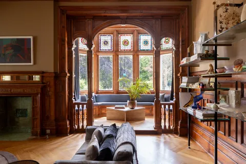 Tall stained-glass bay window with window seats and decorative timber framing in a 19th-century Victorian residence, St Leonards-on-Sea, Hastings, East Sussex, England [1600x1067]