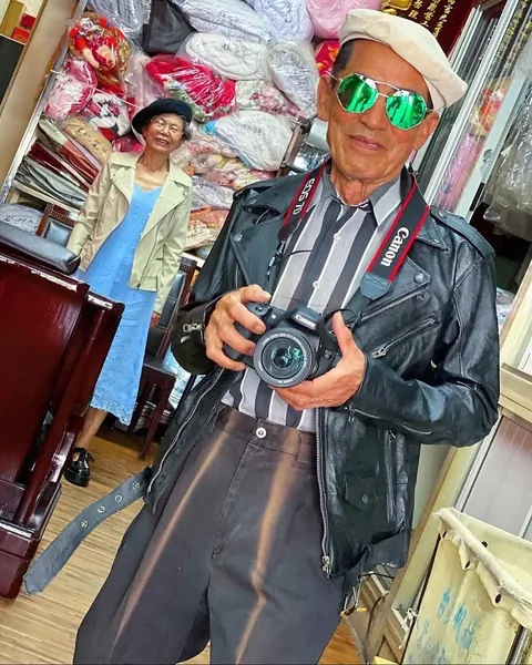 Taiwanese couple wear clothes that were left behind at their laundromat.