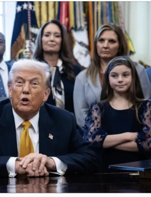 Child stares at the President of the United States.