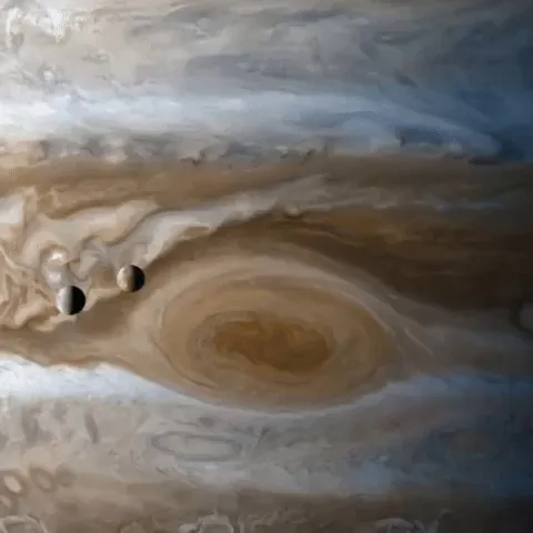 The moons lo and Europa passing by Jupiter, caught by Cassini(An old video but it's still cool)