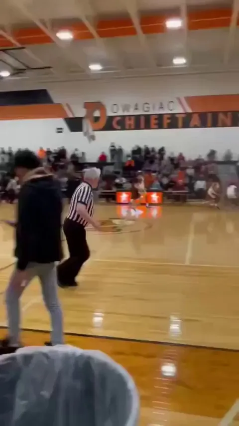 A Michigan assistant basketball coach has been fired after police say he and at least one of his players threw multiple objects at a referee after a game, knocking the referee to the ground