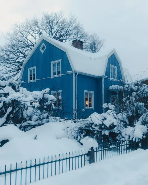 Blue gambrel-roofed house in Stockholm, Sweden.