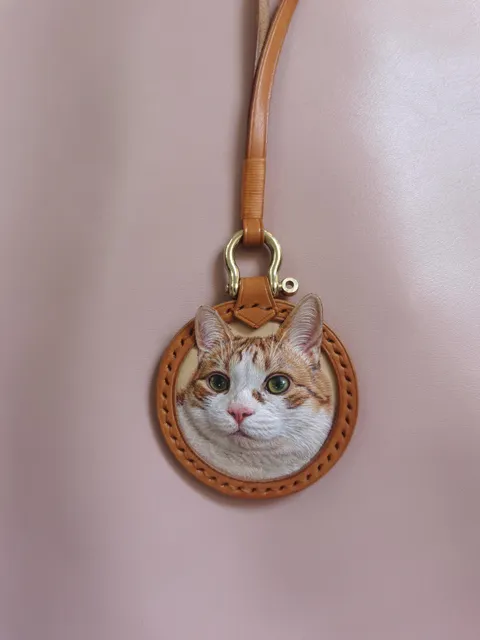 I made a 3D-style keychain of my friend’s orange tabby using a single piece of leather.