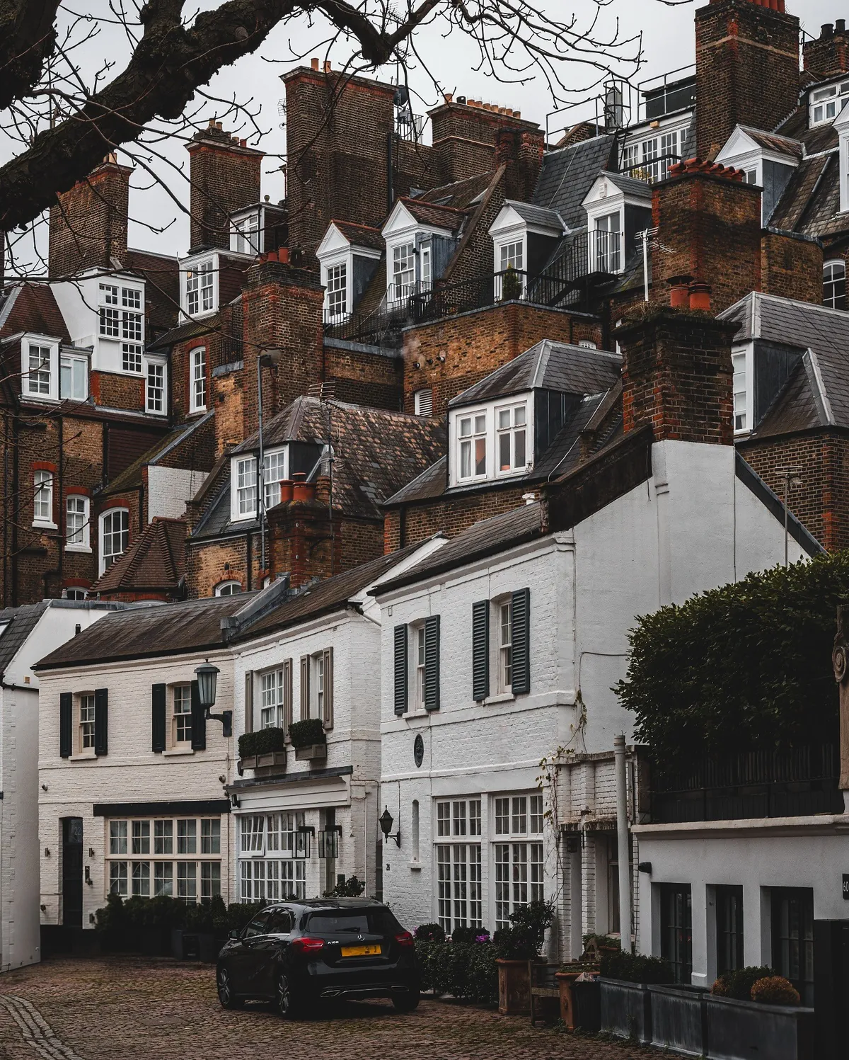 The many dormers and chimneys of townhouses in Knightsbridge, London, UK.