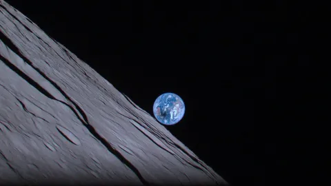 The moon casts a shadow over Australia during a total solar eclipse, as the Earth rises over the moon's horizon. Days before Japan's Hakuto-R lunar lander  crashed into the moon's surface on  April 25, 2023, it snapped this picture of Earth.