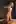 Nude slave girl restrained to post