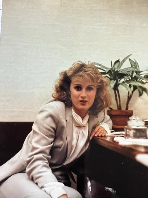 1977, my mother in trouble for breaking the recently created female dress code at IBM. Her suit color is too light. She and her mentor are strategizing how to either change the rules or explain the problem away.
