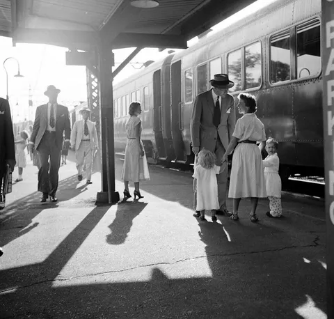 A father is greeted by his family after returning home from work, Fairfield County, Connecticut, 1949.