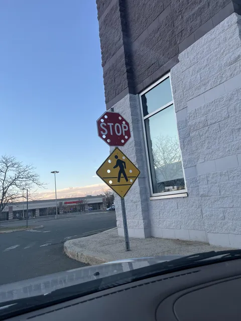 These signs have holes in them to prevent wind from pulling them down