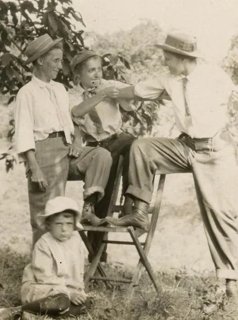 A group of Men and Women goofing around and switching clothes C 1910.