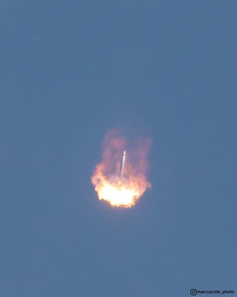 I captured a Falcon 9 booster engulfed in its own rocket flame as it descended back to Cape Canaveral for a landing.
