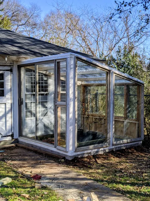 When life gives you a bunch of giant windows and sliding glass doors for $60, you build a greenhouse. Just in time for spring!