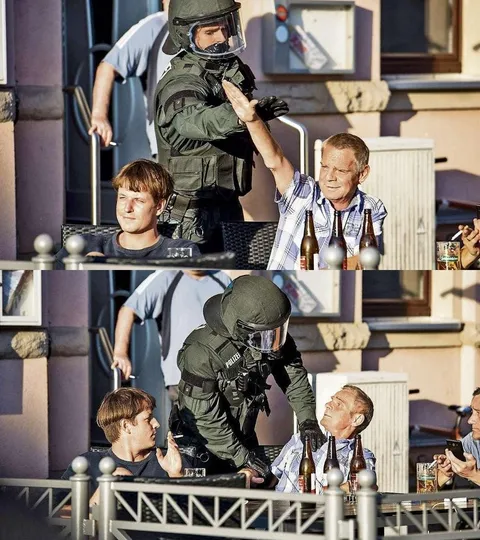 German police officer stops Nazi salute next to a protest